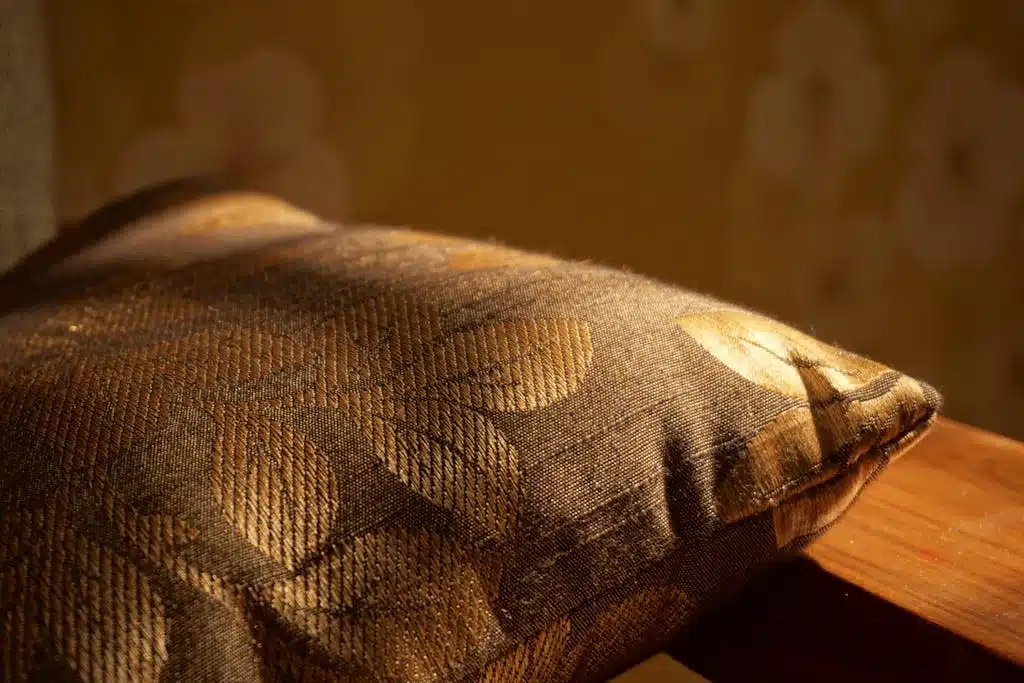 Gold Pillow on Brown Wooden Surface