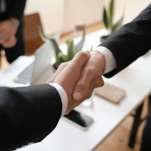Shallow Focus of Two People Handshaking